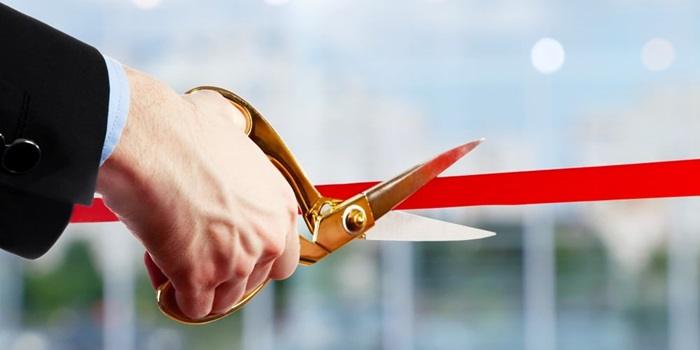 bigstock Businessman cutting red ribbon 130154564